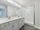 Bright main bathroom featuring double vanity, and a glass-enclosed shower at 113 Alluvium Ln, Waxhaw, NC 28173
