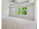 Spacious main bedroom featuring natural light and a tray ceiling with fan at 113 Alluvium Ln, Waxhaw, NC 28173