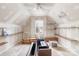 Unfinished attic space with shelving and window at 116 Miller Farm Rd, Statesville, NC 28625