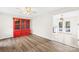 Dining area featuring wood floors, red china cabinet and view into adjacent kitchen at 116 Miller Farm Rd, Statesville, NC 28625