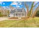 Charming home featuring a welcoming front porch, dormer windows, and a well-manicured front yard at 116 Miller Farm Rd, Statesville, NC 28625