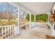 Inviting covered front porch with white columns and wooden floors, perfect for relaxing outdoors at 116 Miller Farm Rd, Statesville, NC 28625