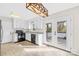 Cozy kitchen featuring modern light fixture, white cabinets, and a view of the wooden deck at 116 Miller Farm Rd, Statesville, NC 28625
