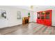 Cozy living room featuring wood floors, an electric fireplace, and a decorative red cabinet at 116 Miller Farm Rd, Statesville, NC 28625