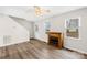 Bright living room with wood floors, fireplace, ceiling fan, and a view through two windows at 116 Miller Farm Rd, Statesville, NC 28625