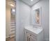 Clean half bath features a vanity with a mirror and modern fixtures at 11611 Old Aquadale Rd, Norwood, NC 28128