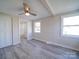 Updated bedroom boasts wood-look floors, closet, ceiling fan, and an en suite bathroom with modern finishes at 11611 Old Aquadale Rd, Norwood, NC 28128