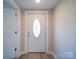 Bright entryway featuring a stylish front door with decorative glass and light wood-look flooring at 11611 Old Aquadale Rd, Norwood, NC 28128