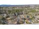 An aerial view showcases a neighborhood surrounded by a beautiful forest with mountain views at 1221 20Th Nw Ave, Hickory, NC 28601
