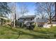 Expansive backyard with lush green grass, mature trees, and a patio area for relaxation at 1221 20Th Nw Ave, Hickory, NC 28601