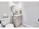 Cozy half bathroom showcasing vanity with a unique mirror and gold hardware at 1221 20Th Nw Ave, Hickory, NC 28601