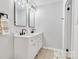 Bright bathroom featuring a dual sink vanity with modern black hardware and framed mirrors at 1221 20Th Nw Ave, Hickory, NC 28601
