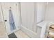 Clean white tiled bathroom with a shower-tub combo and a linen closet at 1221 20Th Nw Ave, Hickory, NC 28601