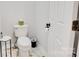Cozy bathroom featuring a toilet and tiled floors next to a door and dark hardware at 1221 20Th Nw Ave, Hickory, NC 28601