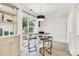 Cozy breakfast nook features an adjacent outdoor patio, modern light fixture, and stylish seating for four at 1221 20Th Nw Ave, Hickory, NC 28601
