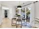 Bright breakfast nook features an adjacent outdoor patio, modern light fixture, and stylish seating for four at 1221 20Th Nw Ave, Hickory, NC 28601