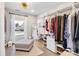 Bright walk in closet featuring wood floors, an ottoman and custom shelving for storage at 1221 20Th Nw Ave, Hickory, NC 28601