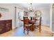 Well-lit dining room features hardwood floors, a decorative light fixture, and a large window at 1221 20Th Nw Ave, Hickory, NC 28601