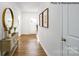 Bright entryway with hardwood floors, neutral walls, and a view of the front door at 123 Meadowview Dr, Statesville, NC 28677