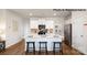 Modern kitchen with white cabinets, an island with seating, and stainless steel appliances at 123 Meadowview Dr, Statesville, NC 28677