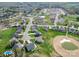 Aerial view of a residential neighborhood with green lawns, mature trees, and a nearby golf course at 139 Tenth Green Ct, Statesville, NC 28625