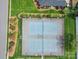 Aerial view of a tennis court in a neighborhood surrounded by lush green trees and manicured lawns at 139 Tenth Green Ct, Statesville, NC 28625