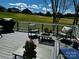Spacious back deck with chairs and furnishings overlooking the manicured yard at 139 Tenth Green Ct, Statesville, NC 28625