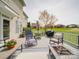 Spacious back deck with outdoor seating, fire pit, grill, and expansive green lawn at 139 Tenth Green Ct, Statesville, NC 28625