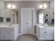 Bathroom featuring dual vanities with white cabinets and tile flooring at 139 Tenth Green Ct, Statesville, NC 28625