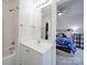 Bathroom with tub/shower combo, and a glimpse into a bedroom with door to exterior at 139 Tenth Green Ct, Statesville, NC 28625