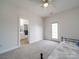 Bedroom featuring a partial view of a bed and a bathroom with tub and shower at 139 Tenth Green Ct, Statesville, NC 28625