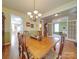Traditional dining room featuring a wooden table, chandelier, and hardwood floors at 139 Tenth Green Ct, Statesville, NC 28625
