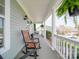 Inviting front porch featuring rocking chairs and charming architectural details at 139 Tenth Green Ct, Statesville, NC 28625