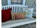 Close-up of a swing with decorative pillows on a covered front porch at 139 Tenth Green Ct, Statesville, NC 28625