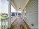 Covered front porch with swing and view of the neighborhood at 139 Tenth Green Ct, Statesville, NC 28625