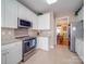Bright kitchen with granite countertops, white cabinets, and stainless steel appliances at 139 Tenth Green Ct, Statesville, NC 28625
