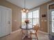 Eat-in kitchen nook with a round table, chandelier, and bright window at 139 Tenth Green Ct, Statesville, NC 28625