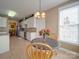 Eat-in kitchen area showcases a cozy table, chandelier, and ample natural light at 139 Tenth Green Ct, Statesville, NC 28625