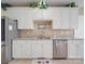 Bright kitchen with granite countertops, white cabinets, and stainless steel appliances at 139 Tenth Green Ct, Statesville, NC 28625