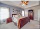 Main bedroom features a king-size bed, ceiling fan, and stylish decor at 139 Tenth Green Ct, Statesville, NC 28625