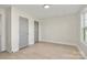 Neutral bedroom featuring wood-look floors, two closets, and a bright window at 141 Ark St, Kings Mountain, NC 28086