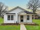 Charming remodeled single story home with black framed windows, a covered porch, and a well manicured lawn at 141 Ark St, Kings Mountain, NC 28086
