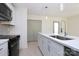 Modern kitchen with stainless steel appliances, white cabinets, and a quartz countertop at 141 Ark St, Kings Mountain, NC 28086