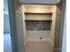 A compact laundry closet offers a practical solution with shelving and tiled backsplash at 141 Ark St, Kings Mountain, NC 28086