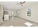 Sunlit living room with wood-look floors, neutral paint, ceiling fan, and abundant windows at 141 Ark St, Kings Mountain, NC 28086