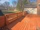 Back deck featuring wood slats, wood railing, and a view of the yard at 14106 Carriage Lake Dr, Charlotte, NC 28273