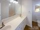 Bathroom featuring a double sink vanity with modern fixtures, ample counter space, and a large mirror at 14106 Carriage Lake Dr, Charlotte, NC 28273
