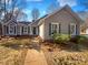 Charming single-story home features gray siding, white-trimmed windows, and a well-maintained front yard at 14106 Carriage Lake Dr, Charlotte, NC 28273