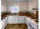 Well-lit kitchen with white cabinets, tile backsplash, and modern appliances at 14106 Carriage Lake Dr, Charlotte, NC 28273