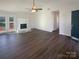Spacious living room with a fireplace, hardwood floors, and access to an outdoor deck at 14106 Carriage Lake Dr, Charlotte, NC 28273